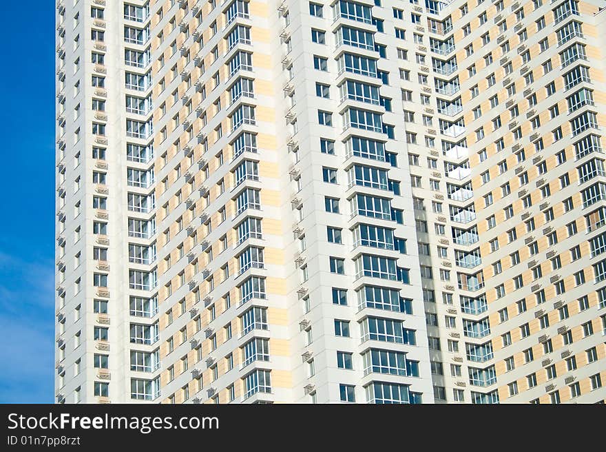 Condominium in urban area against blue sky