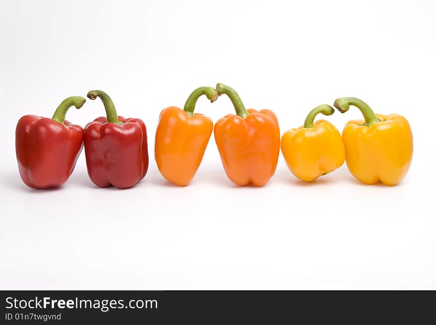 Sweet peppers. Pepper. Bright colorful sweet peppers isolated on white. Amorous twosomes of colorful sweet peppers. . Sweet peppers. Pepper. Bright colorful sweet peppers isolated on white. Amorous twosomes of colorful sweet peppers.