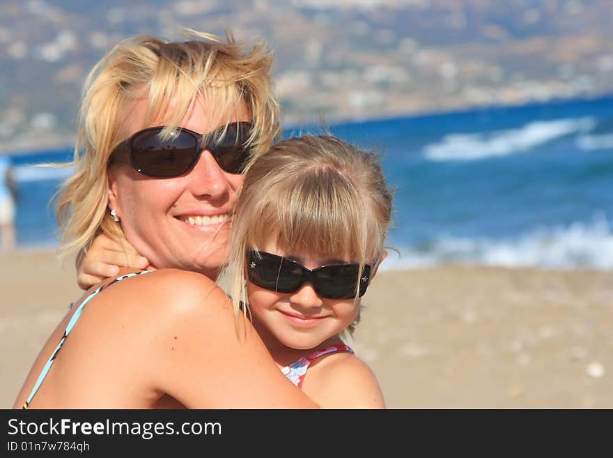 Happy mum with a daughter have a rest on the sea