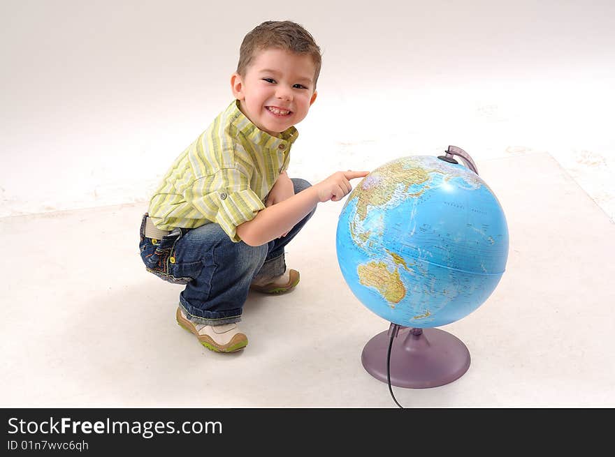 Smiling boy studying globe