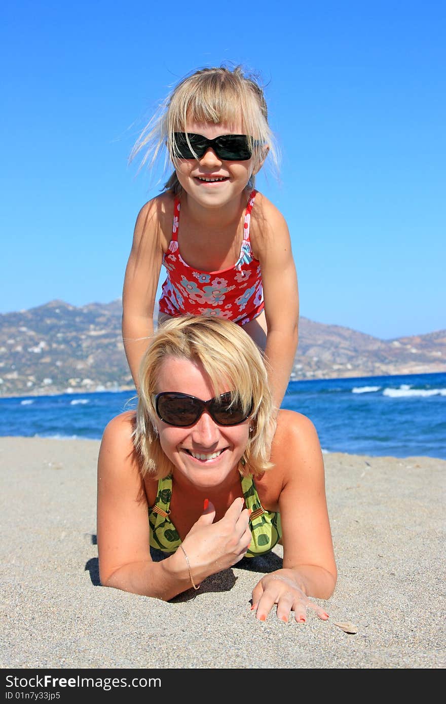 Happy mum with a daughter have a rest on the sea