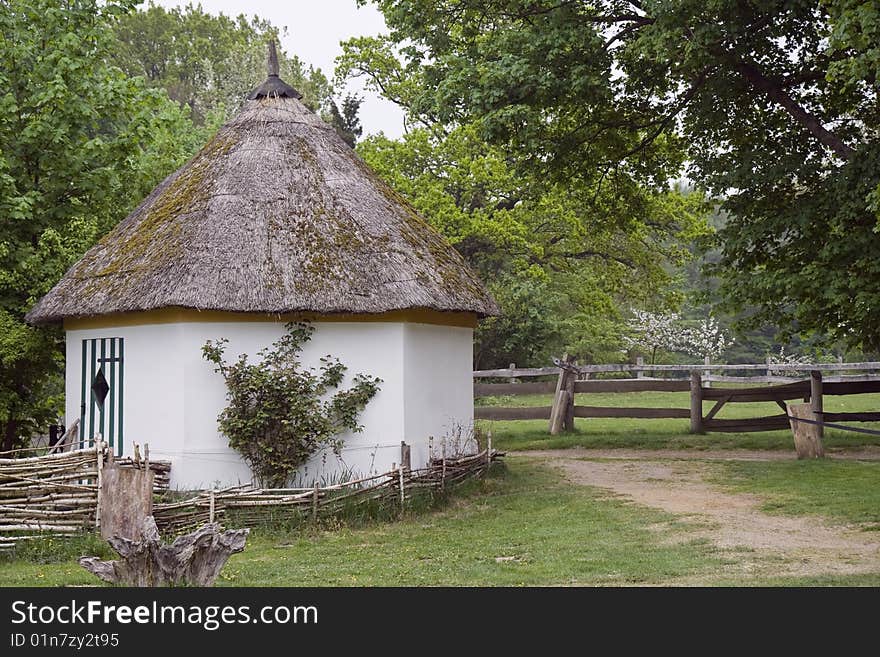 Hexagonal cottage with thatched roof. Shot from Küchensee, Germany