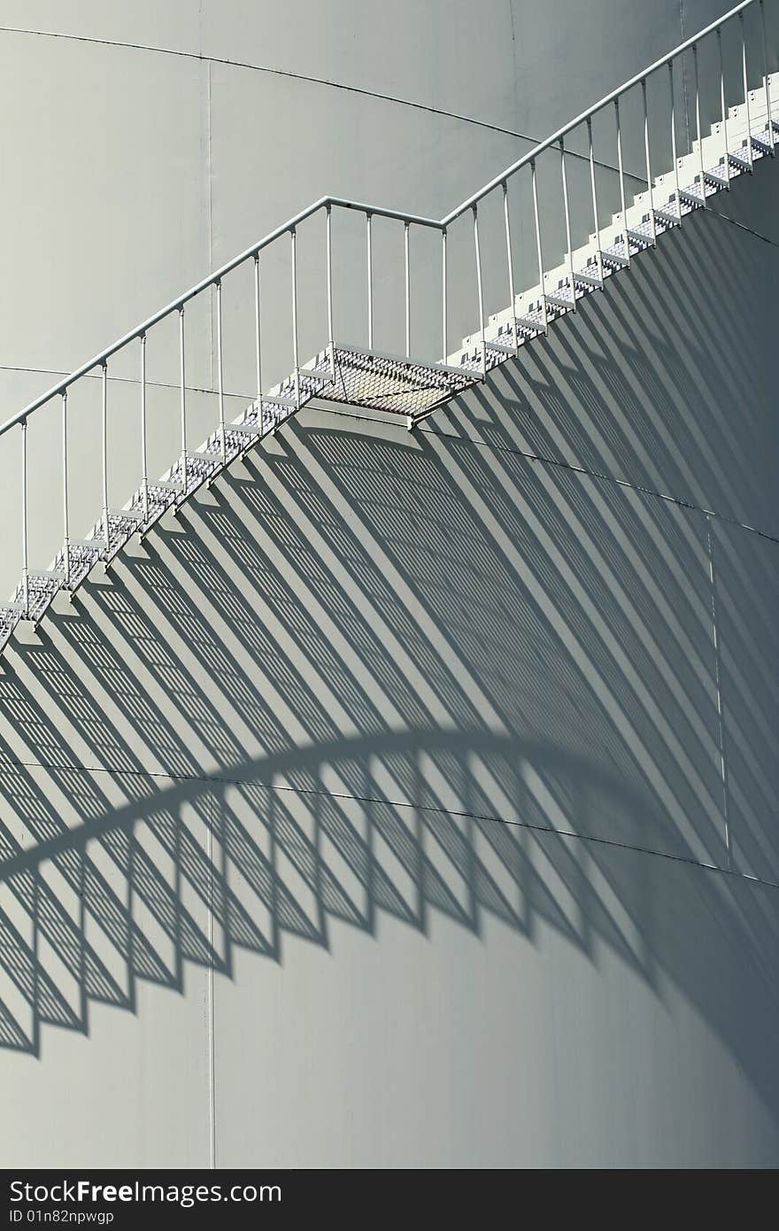 Oil storage tank with spiral staircase and its shadow. Oil storage tank with spiral staircase and its shadow