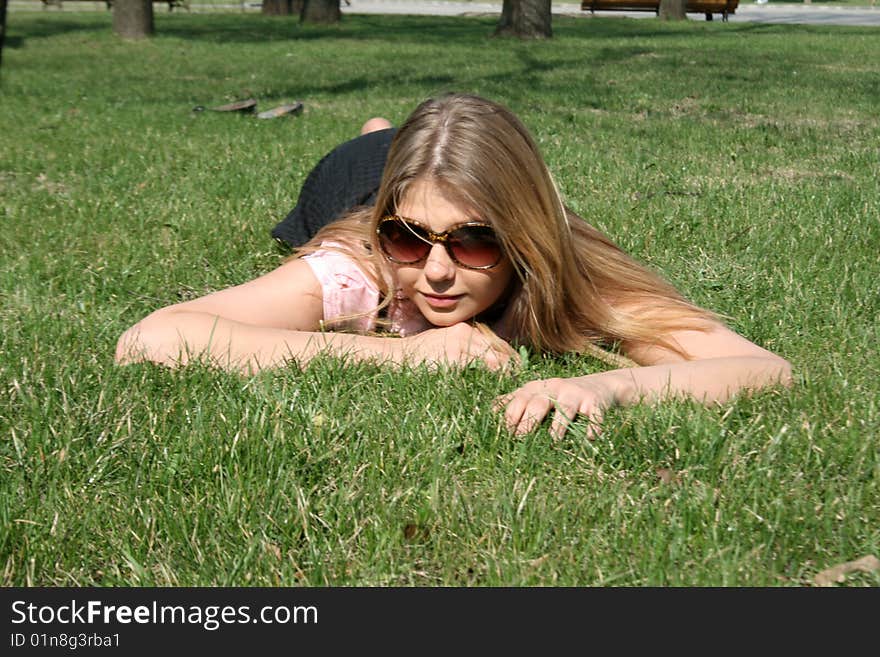 Girl lying on grass in a park