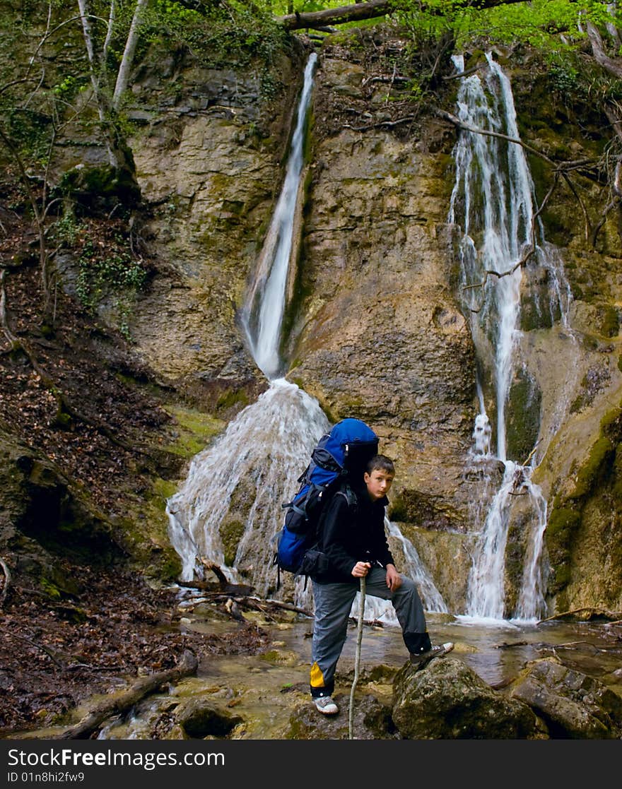 Waterfall And Boy Is Hiker