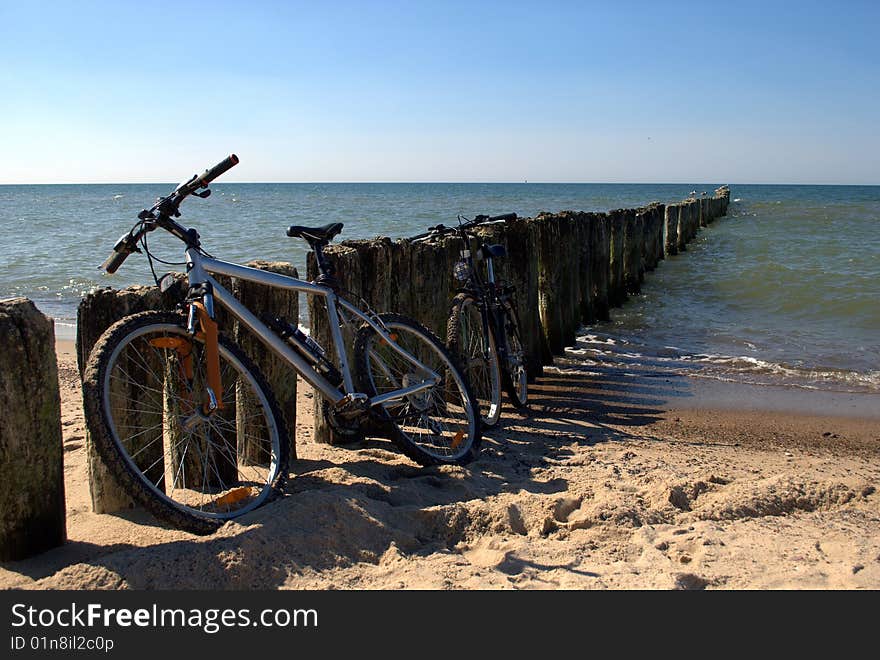 Two bikes near a breakwater