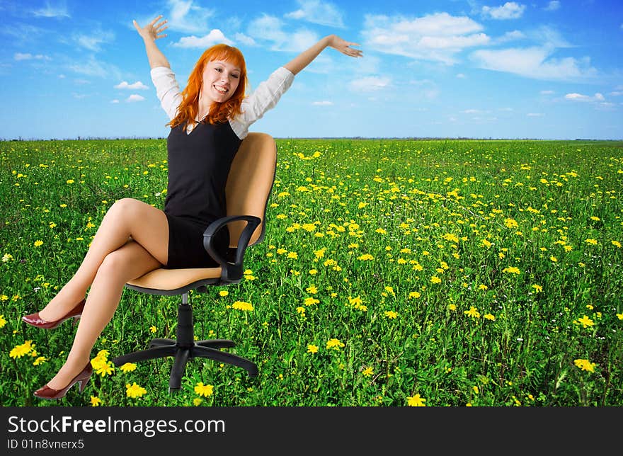 Businesswoman on a beautiful meadow full of flower