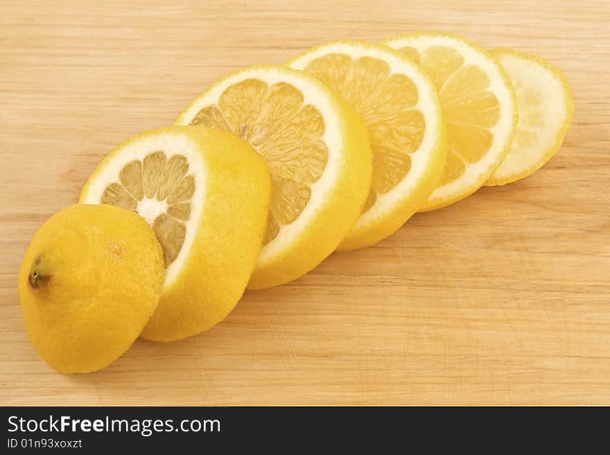 Sliced lemon on wooden background