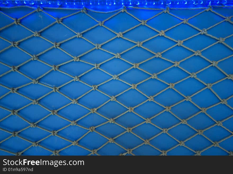 Fishing net on a blue background. Fishing net on a blue background