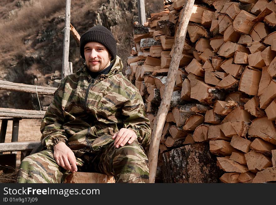 A man near pile of firewood