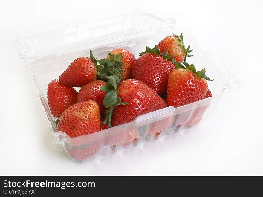 A basket of ripe strawberries on white background. A basket of ripe strawberries on white background.