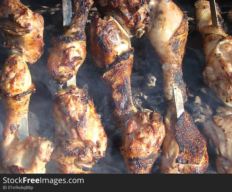 Pieces of a chicken shish kebab are fried over coals