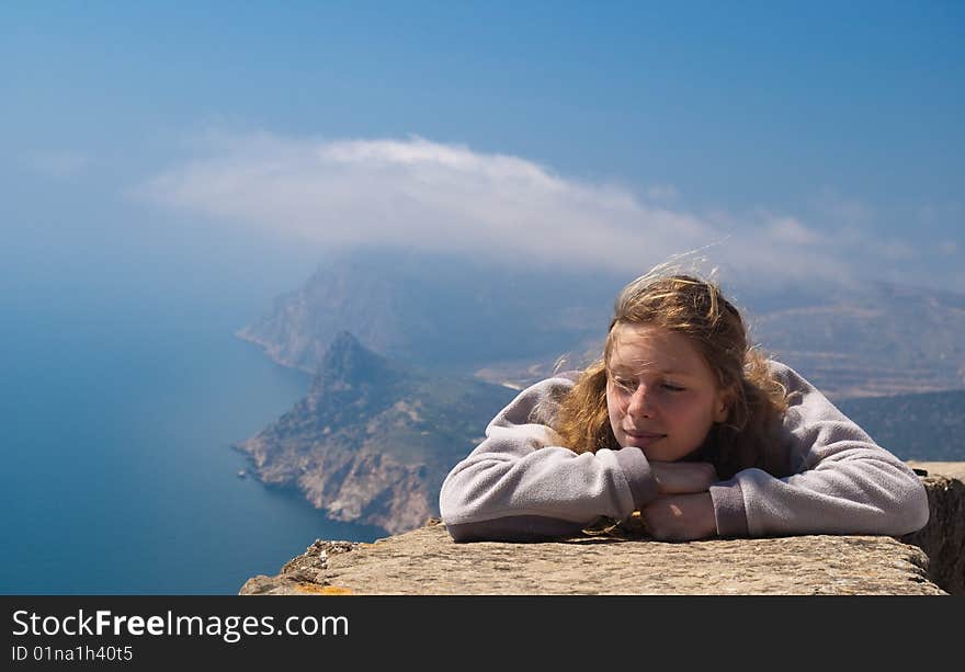 The young woman has a rest against a sea landscape. The young woman has a rest against a sea landscape