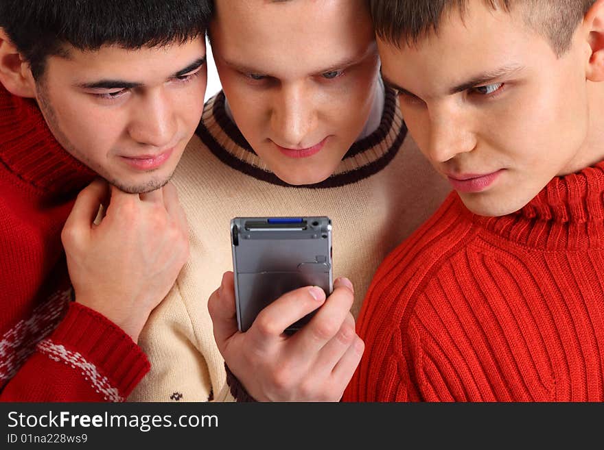 Three friends look on handheld computer