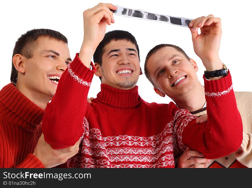 Three friends look at film on white. Three friends look at film on white