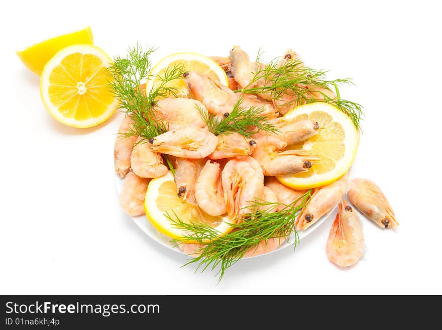 Prawn on dish with lemon isolated on white