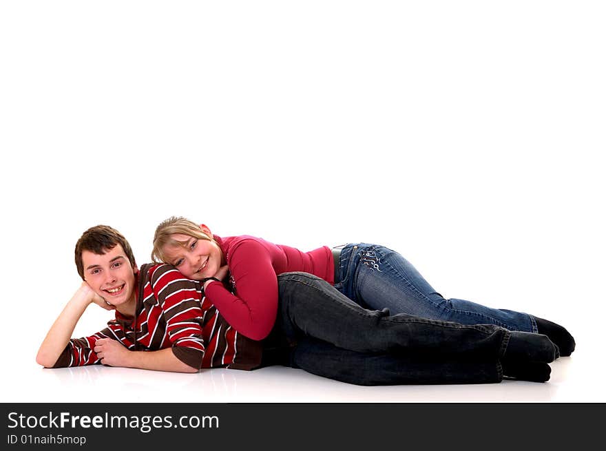 Two casual dressed teenagers, teenage man and woman in love, studio shot, reflective surface. Two casual dressed teenagers, teenage man and woman in love, studio shot, reflective surface