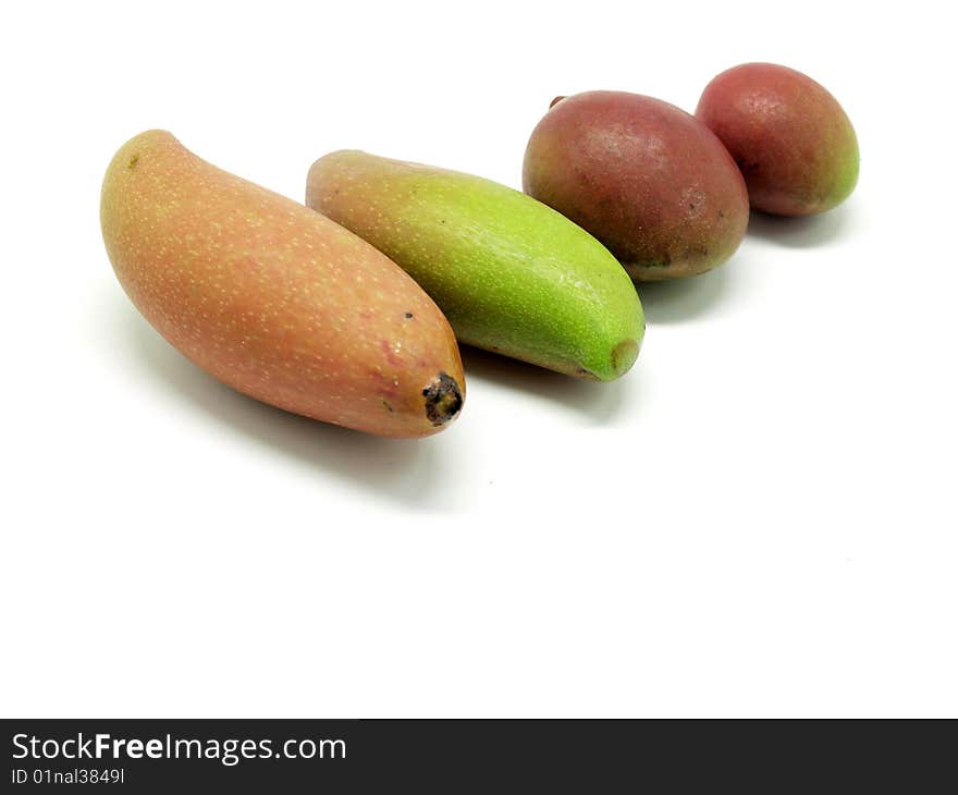 Raw and green  mangoes isolated over white background.