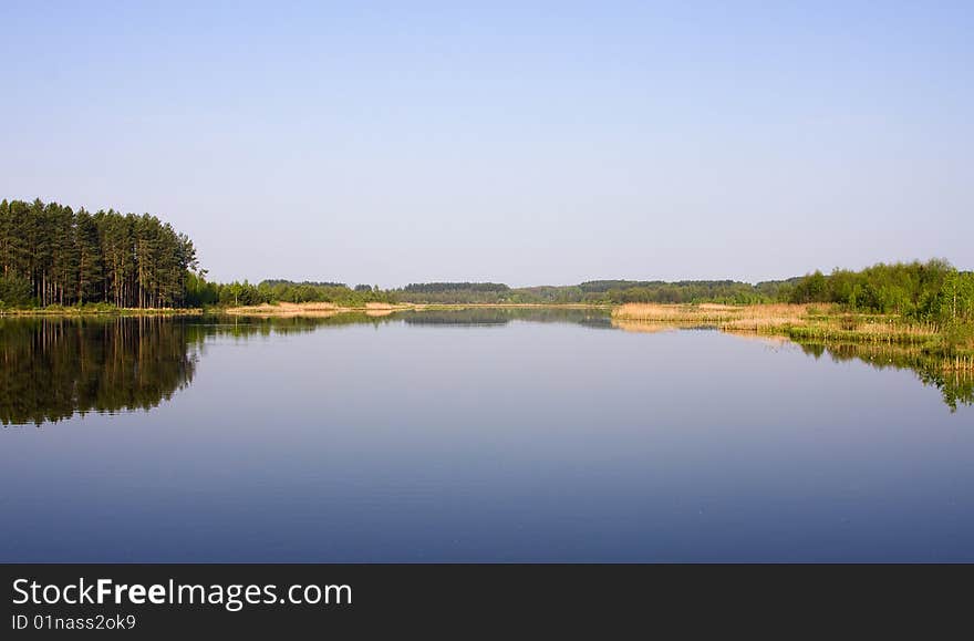 Picturesque landscape spring river and bright trees and bushes, against the backdrop of skies. Picturesque landscape spring river and bright trees and bushes, against the backdrop of skies.