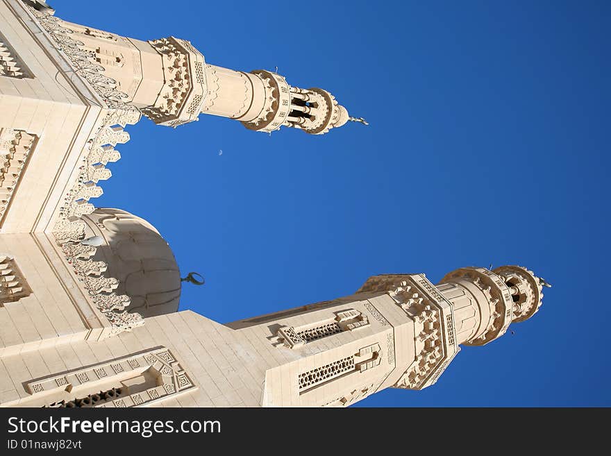 Domes of a minaret with a half moon against the blue sky. Domes of a minaret with a half moon against the blue sky