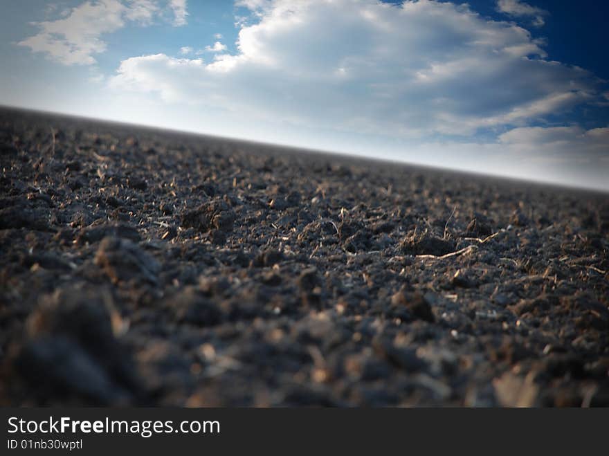 Field Against The Sky With Clouds