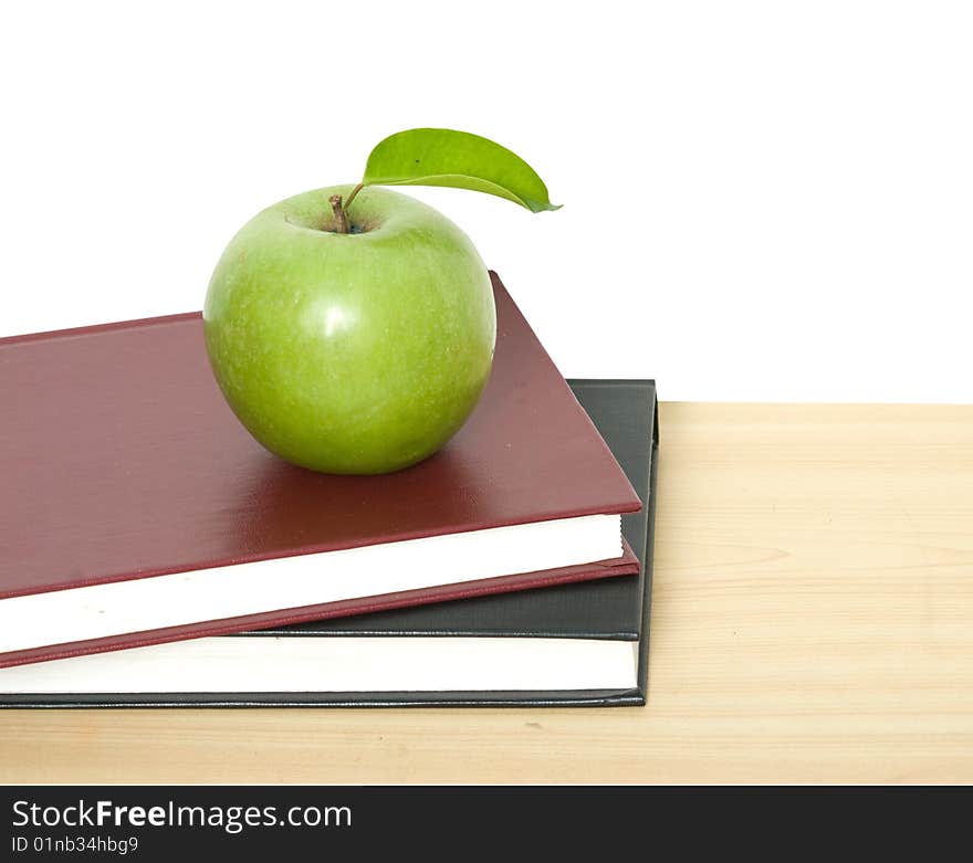 Green apple on books