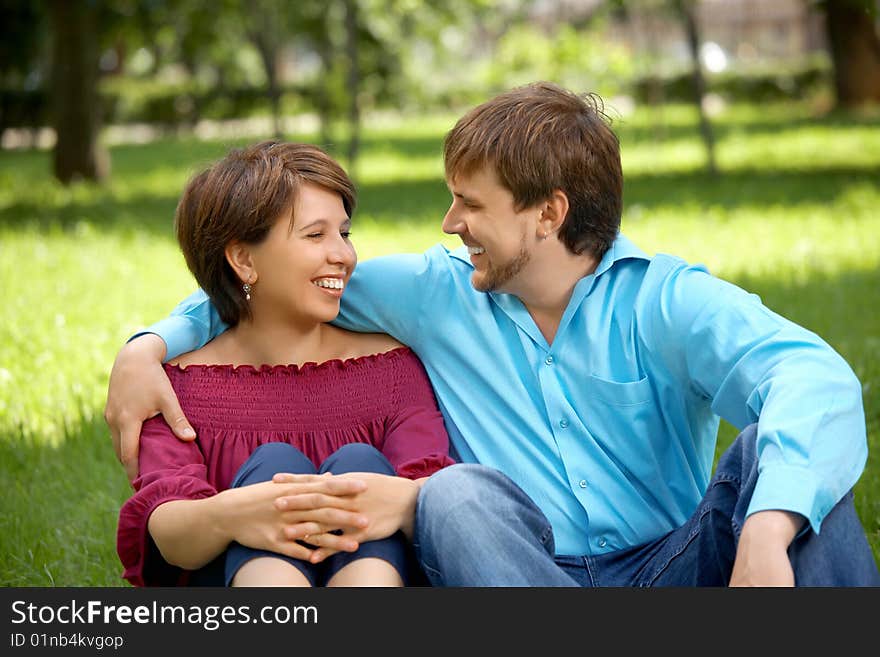 Pair of enamoured adult people in a summer garden. Pair of enamoured adult people in a summer garden