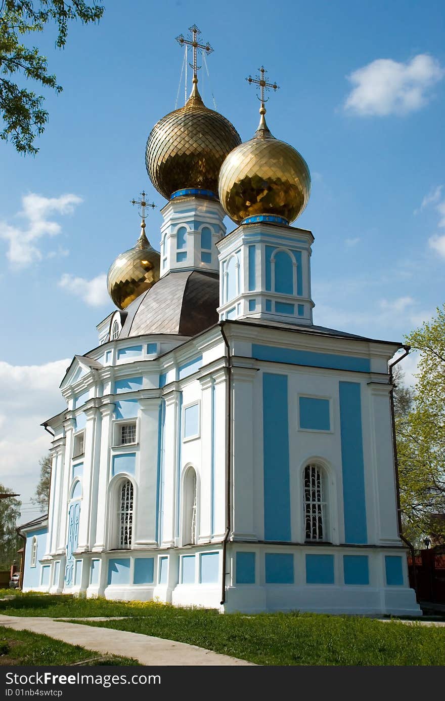 The Christian orthodox temple on background of blue sky. The Christian orthodox temple on background of blue sky