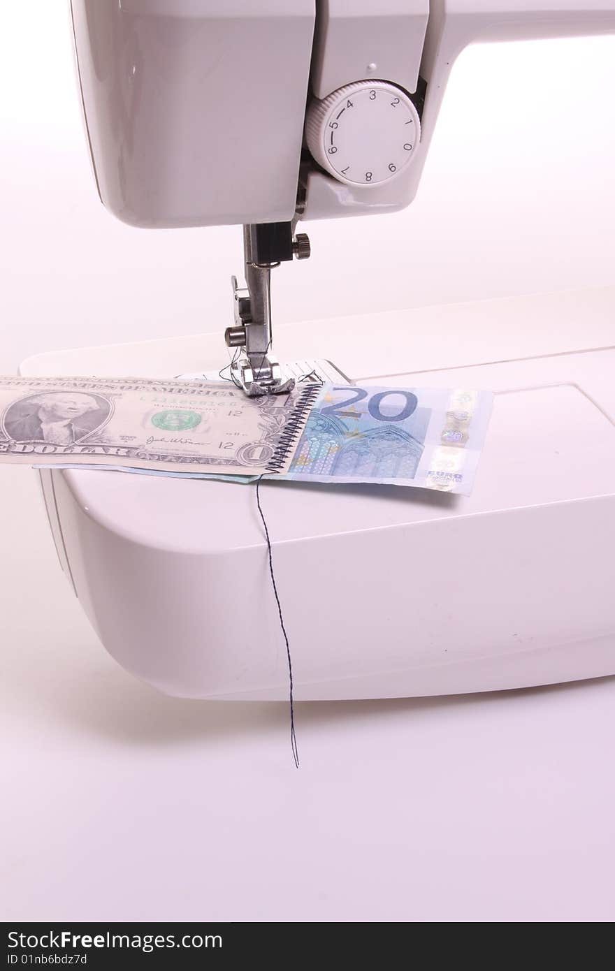 Sewing macihine sews dollar and Euro banknotes. Sewing macihine sews dollar and Euro banknotes