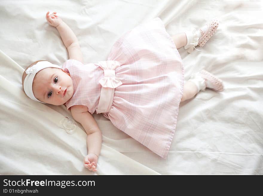 Beautiful newborn girl in beautiful pink dress