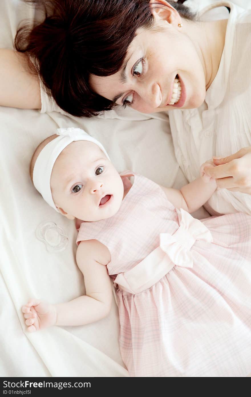 Happy mother lying with her newborn daughter. Happy mother lying with her newborn daughter