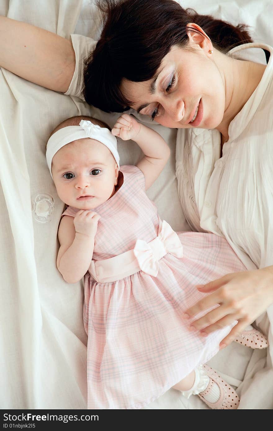 Happy mother lying with her newborn daughter. Happy mother lying with her newborn daughter