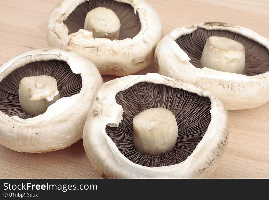 Flat  mushrooms on wooden chopping board. Flat  mushrooms on wooden chopping board