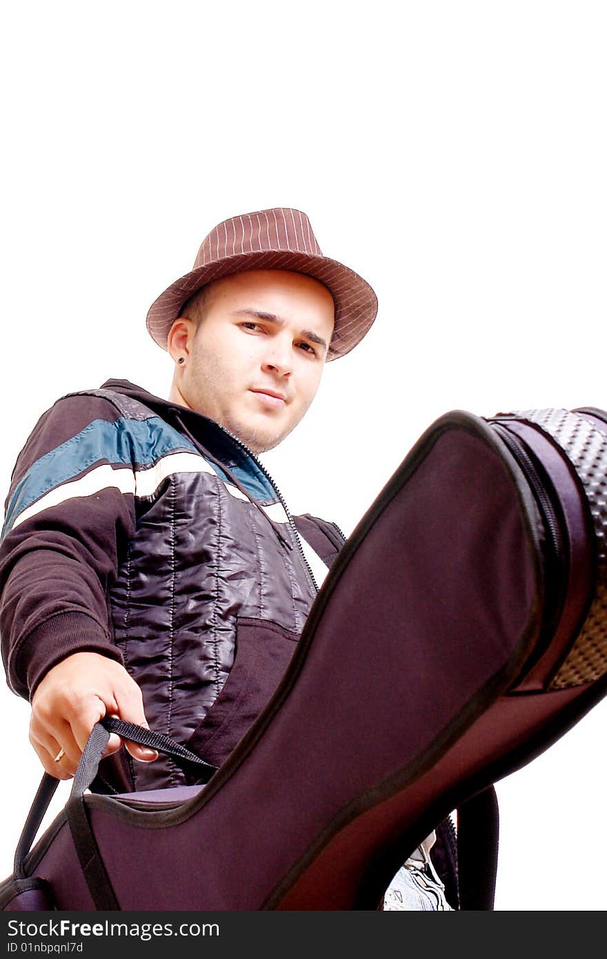 Young man with his guitar looking at camera. Young man with his guitar looking at camera