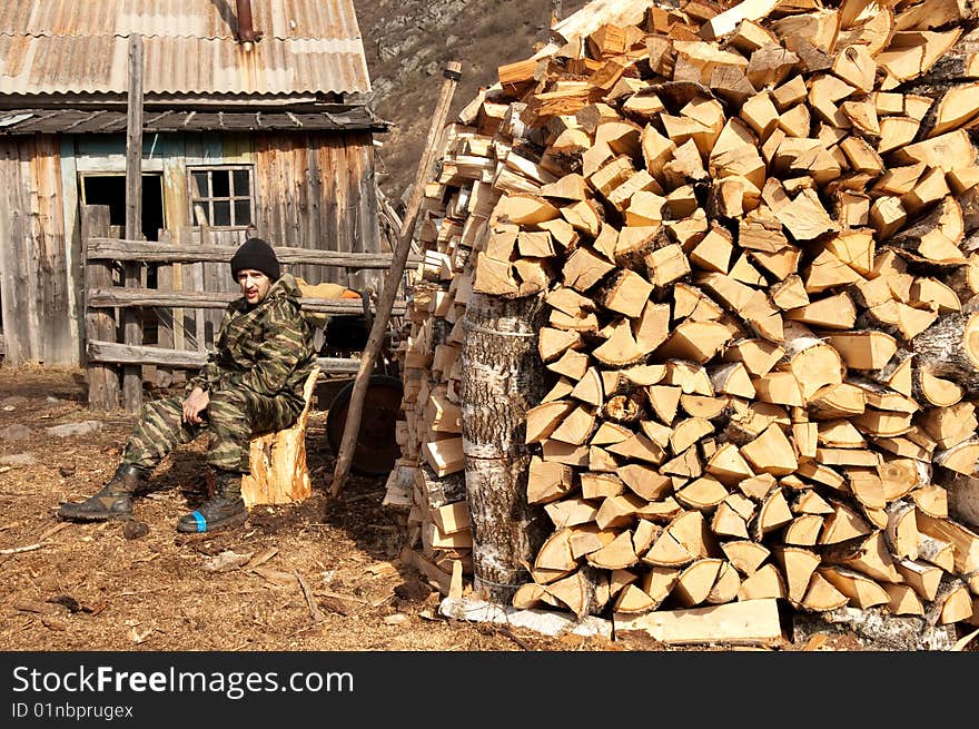 A man near pile of firewood