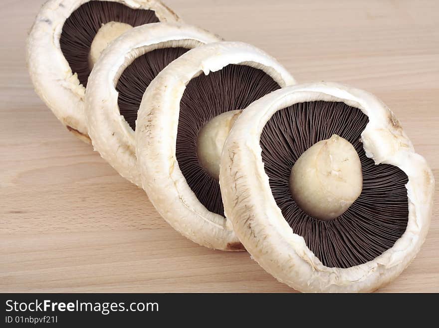 Flat  mushrooms on wooden chopping board. Flat  mushrooms on wooden chopping board