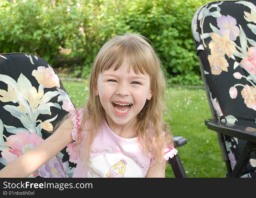 The laughing little girl, in a garden. The laughing little girl, in a garden.