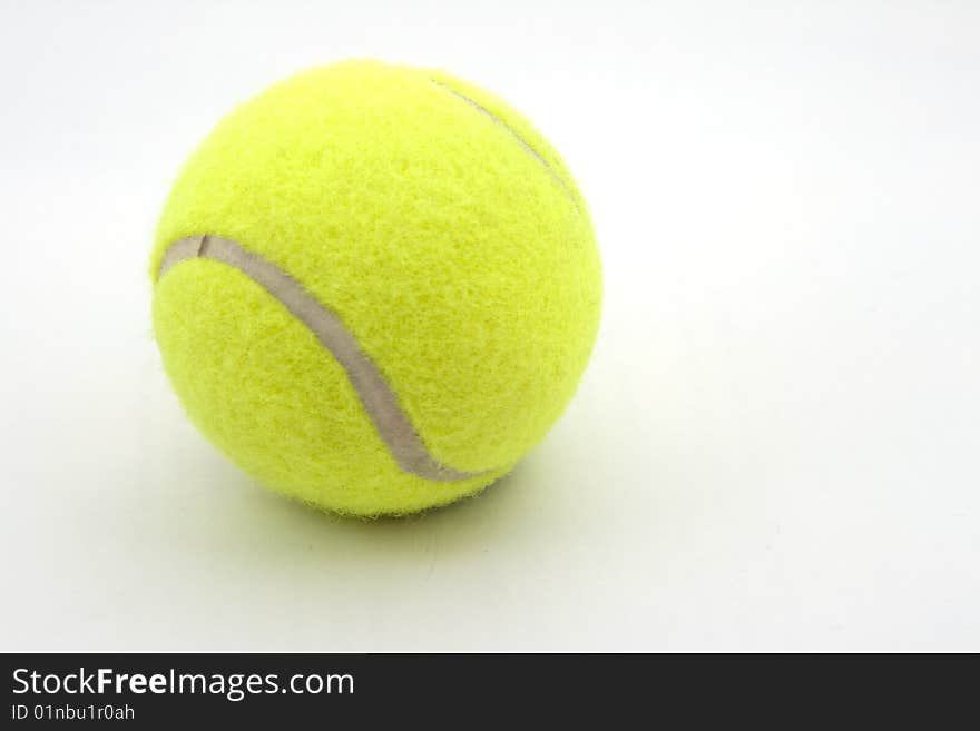 It's a tennis ball that is on a white background. It's a tennis ball that is on a white background.