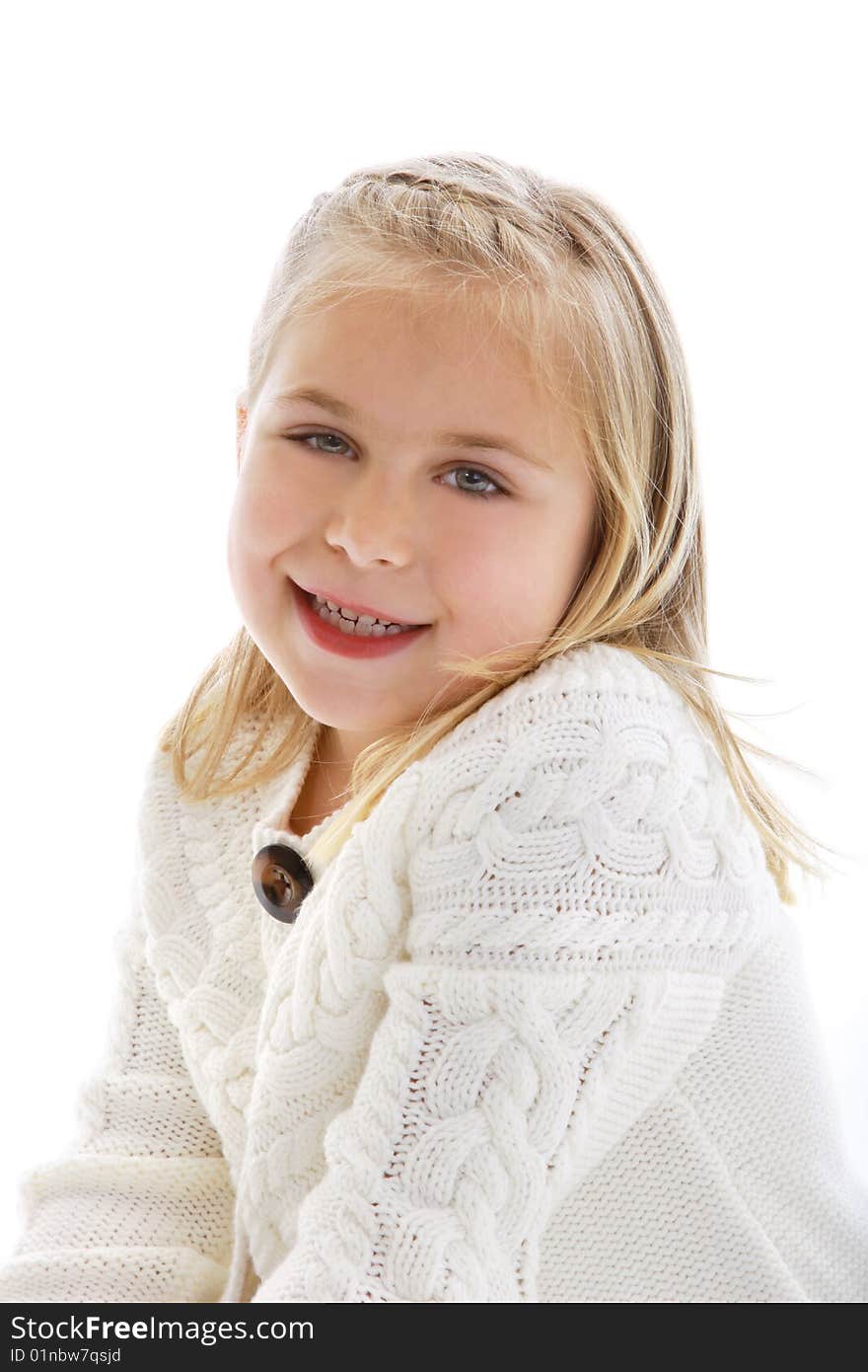 Cute little girl wearing a white sweater.