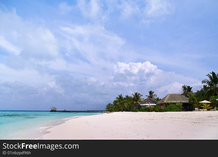 Exotic resort in Maldives under blue sky.