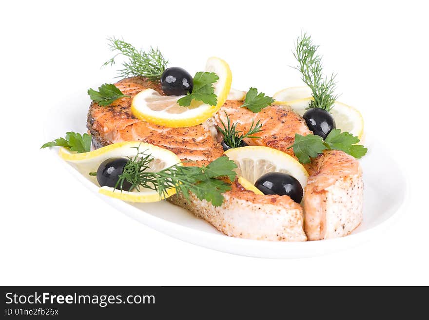 Appetizing Grilled Salmon with lemon, black olives and mixed greens