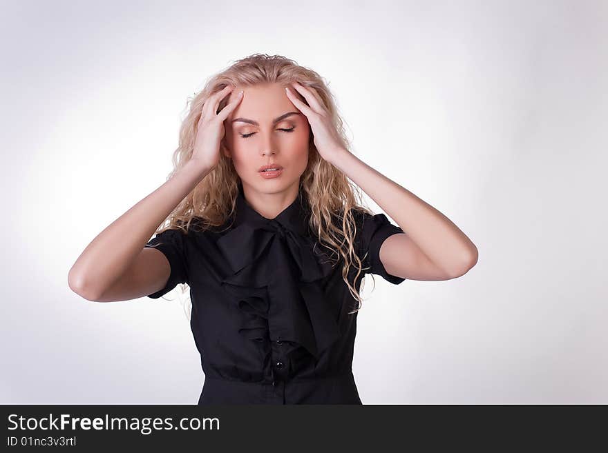 Girl with a headache, studio shot