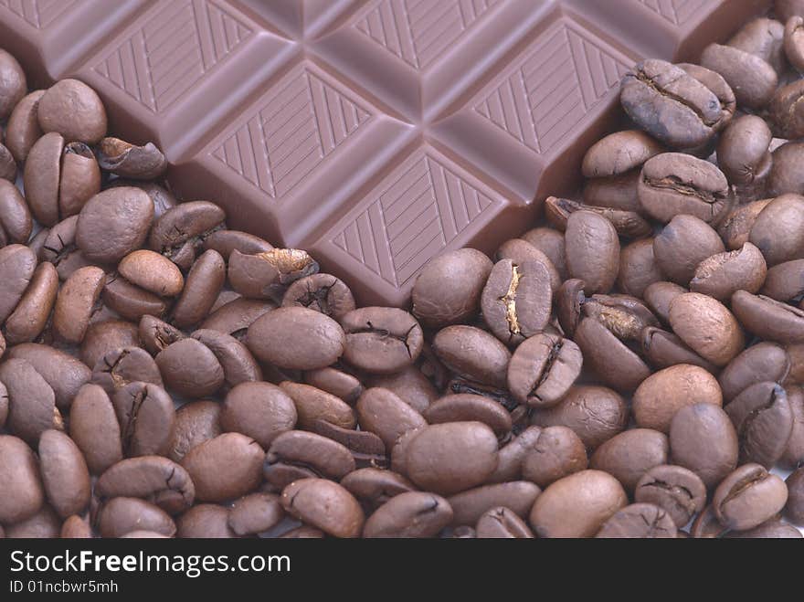 Chocolate on the coffee beans background. Selective focus. Chocolate on the coffee beans background. Selective focus