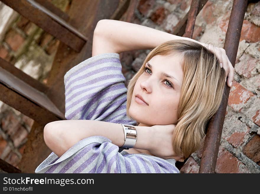 Portrait of young beautiful woman on the stairs