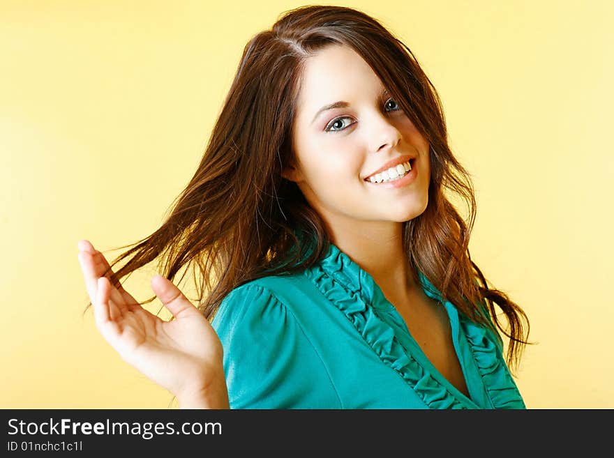 Teen model with a gorgeous smile looking fabulous against a gold backdrop. Teen model with a gorgeous smile looking fabulous against a gold backdrop.