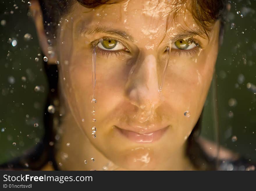 A splash of water in womans face,  closeup