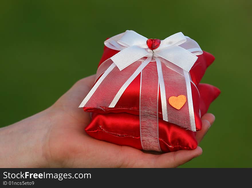 Red gift with heart and green backround. Red gift with heart and green backround