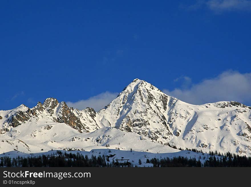 Snow covered mountains with a blue sky