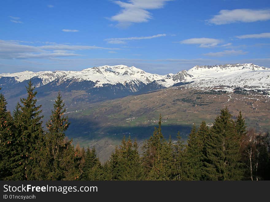 Snow covered mountains with a blue sky