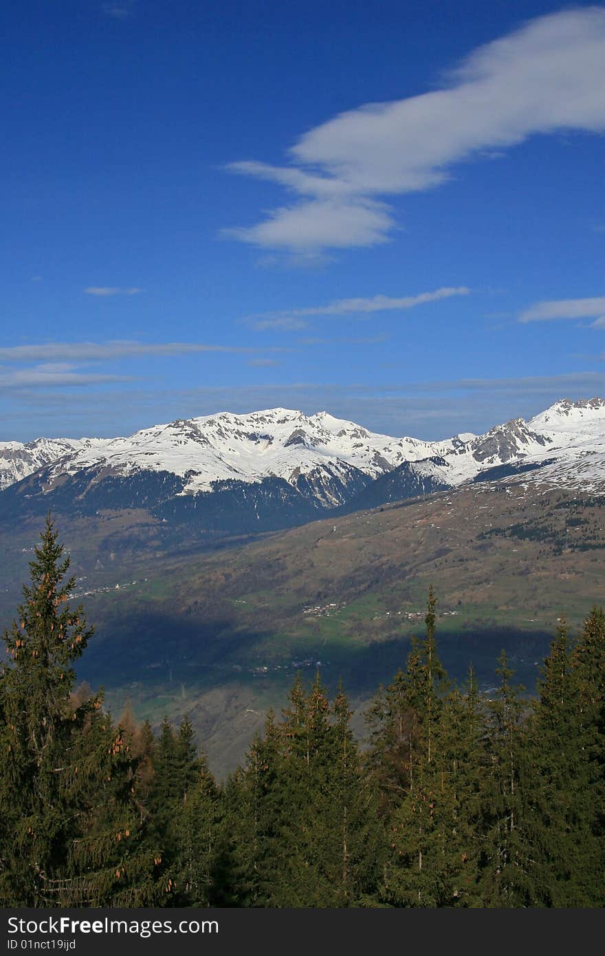 Snow covered mountains with a blue sky